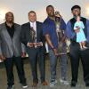 TEAM KRL poses with Frederick Hightower and his sculptures of a mountaineer, Hal Greer and Katherine Johnson.