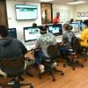 Students writing story about Jarrod West Jr. at Parthenon newsroom.