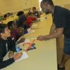 Derek Rankin instructs Anson Fykes as Malik Grier looks on during the branding workshop.