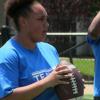 Desiree Wells prepares to throw a football during Day 2 of the 2017 B4 (Be Strong, Be Positive, Be Ready, Believe) youth program June 3 at Marshall Recreation Center.